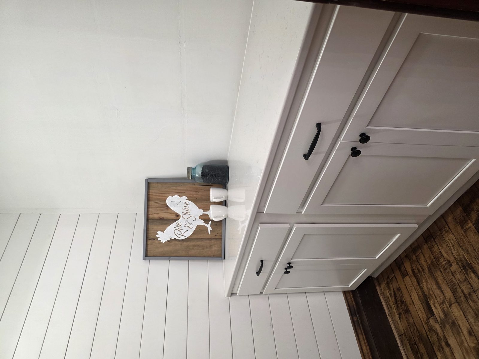 Farmhouse kitchen remodel with white shaker cabinets and hardwood floors